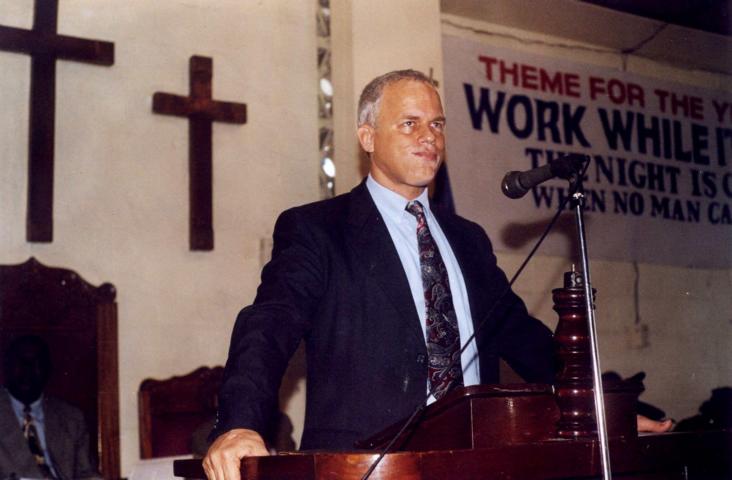 Rev. Mark R. Sheppard, Baptist Mid  Mission Representative preaching at the dedicatory program for the new church office